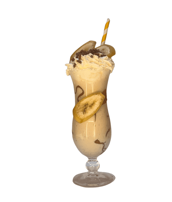 Delicious banana milkshake with whipped cream and chocolate sprinkles.